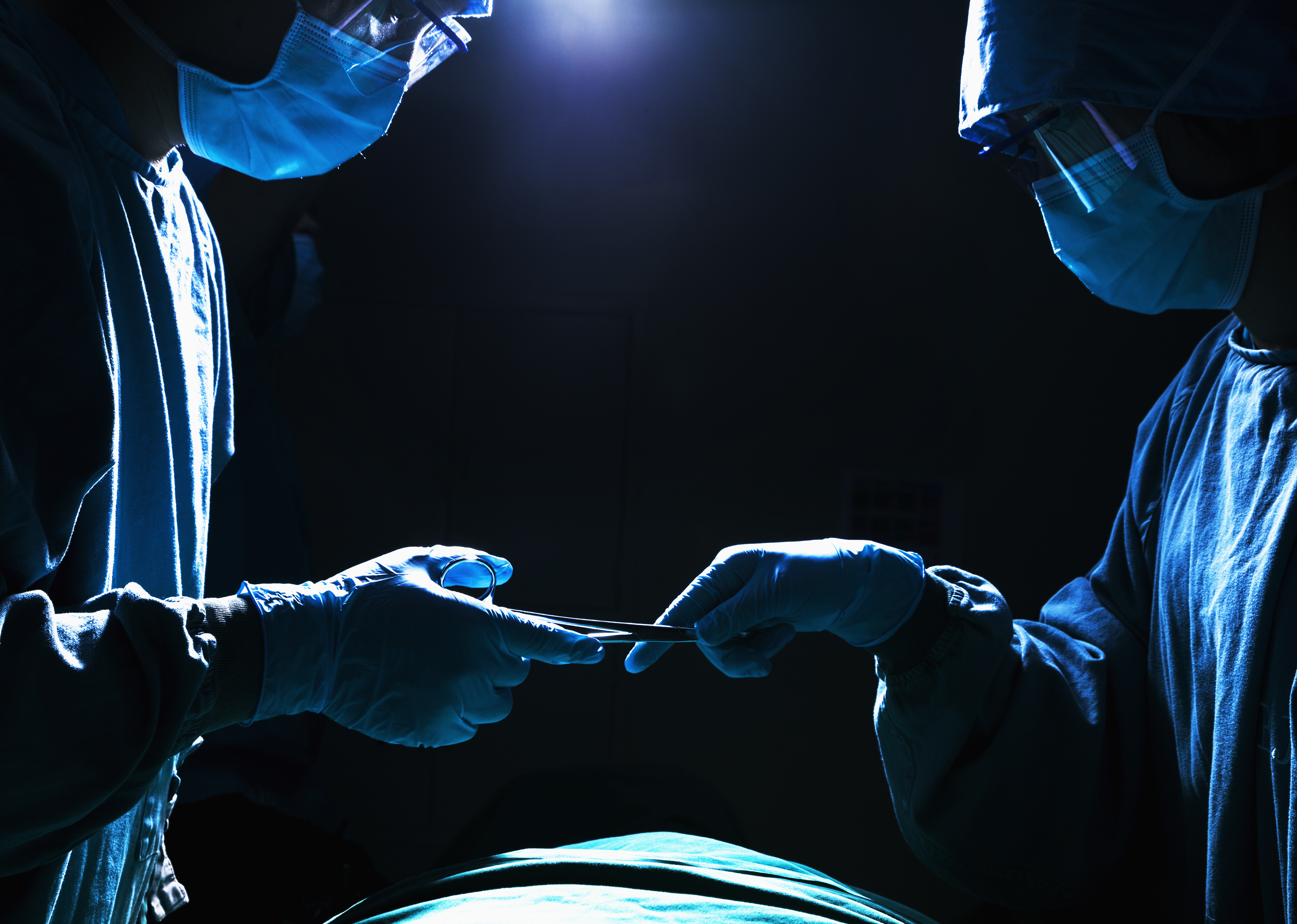 bigstock-Two-surgeons-working-and-passi-52318804.jpg
